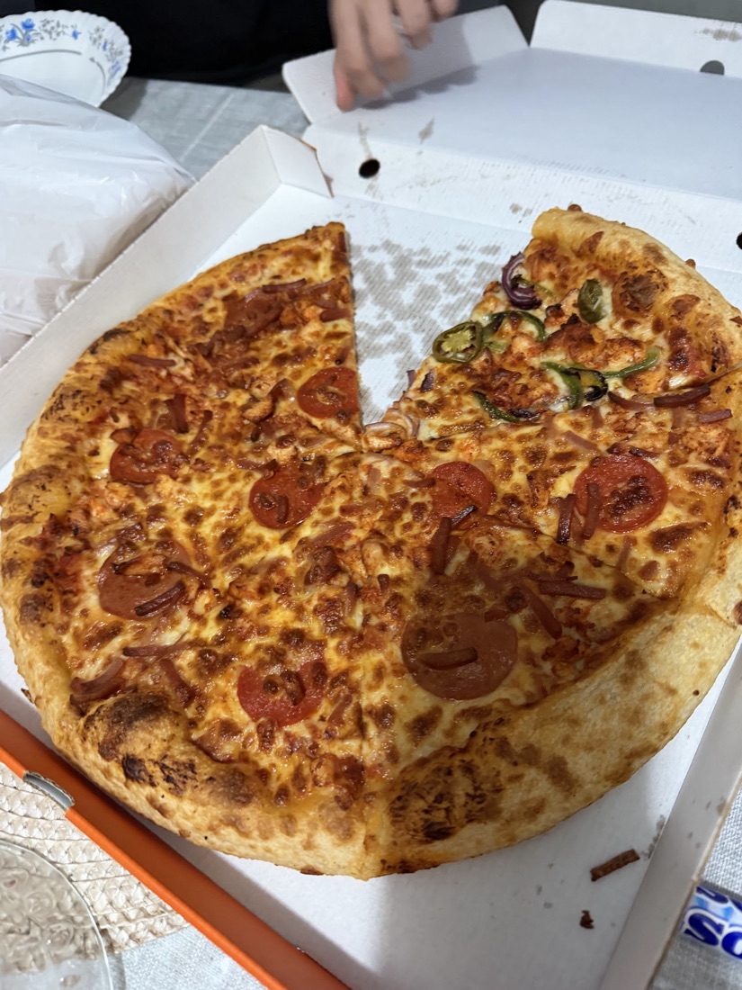 Fresh-dough pepperoni and chicken pizza in the box
